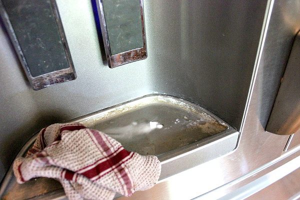 baking soda cleaning water dispenser on fridge at ASlobComesClean