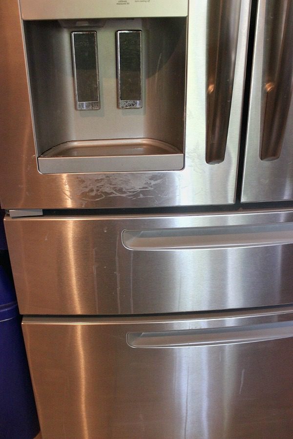 baking soda cleaning fridge front at ASlobComesClean.com